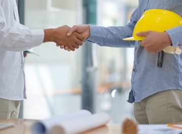 Architects and contractors shake hands to work.