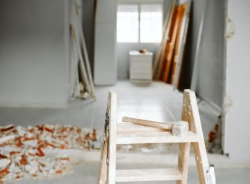 ladder, hammer and debris at home construction site. Home renovation